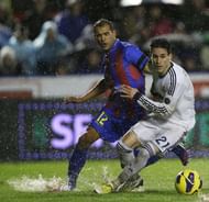 Levante's Juanfran Garcia (L) vies with Real Madrid's Jose Maria Callejon